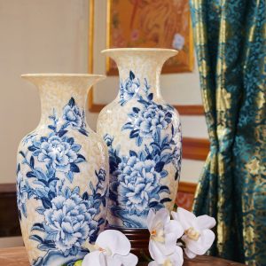 Blue floral porcelain vases holding white orchids in a traditional styled setting.