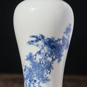Chinese blue-and-white porcelain vase with intricate painted artwork.