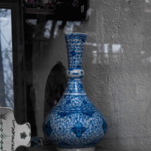 Ornate blue ceramic vase with intricate hand-painted patterns on display.