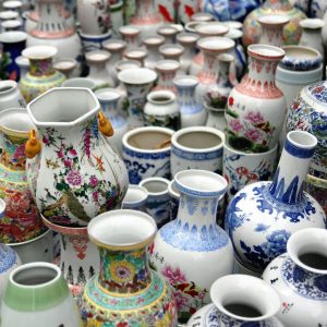 A collection of ceramic vases with intricate floral designs on display.
