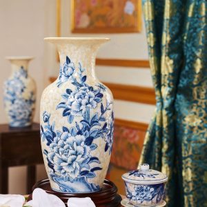 Blue-and-white porcelain vase with floral motifs styled in an interior.
